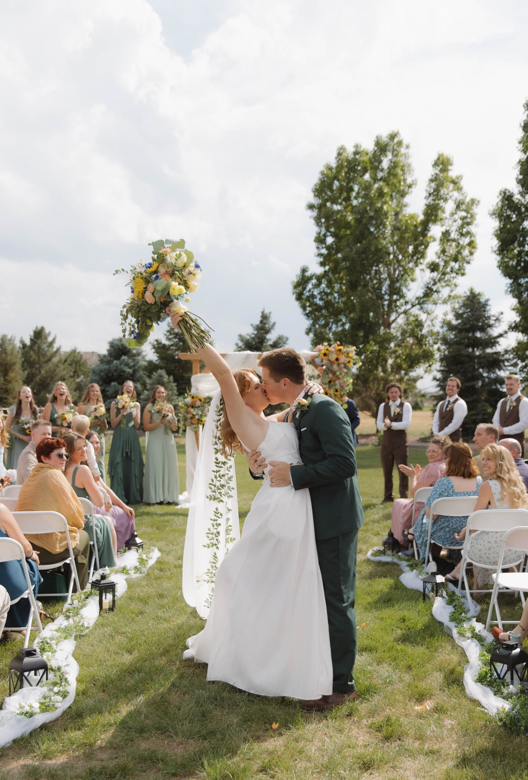 Romantic wedding aisle meadow floral pillars at an outdoor vineyard