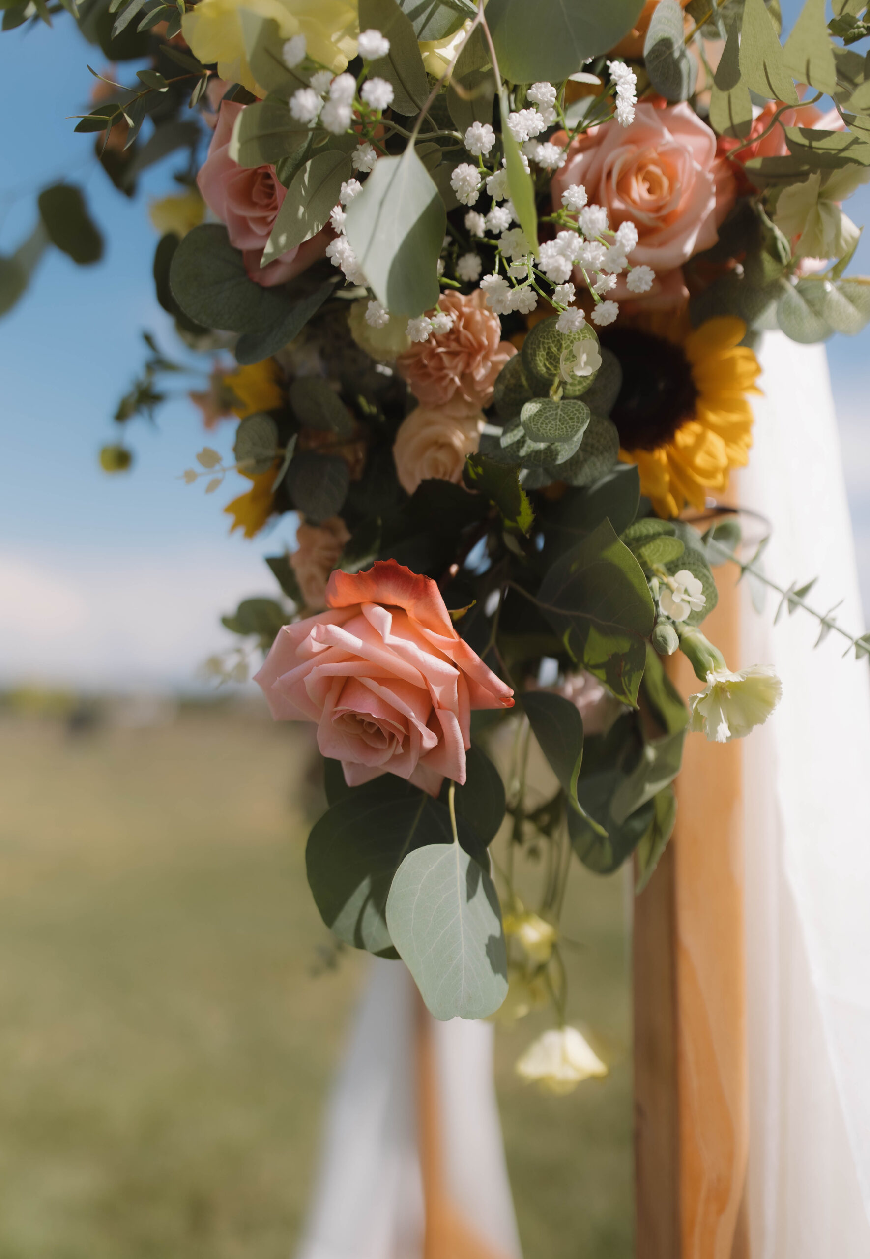 Sweetheart table floral arrangement framing the newlyweds
